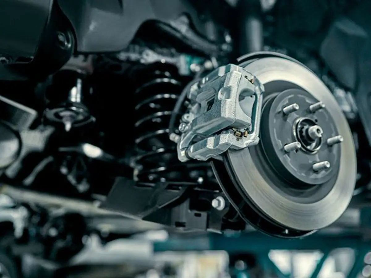 Close-up of a vented brake rotor and caliper mounted on a vehicle wheel hub
