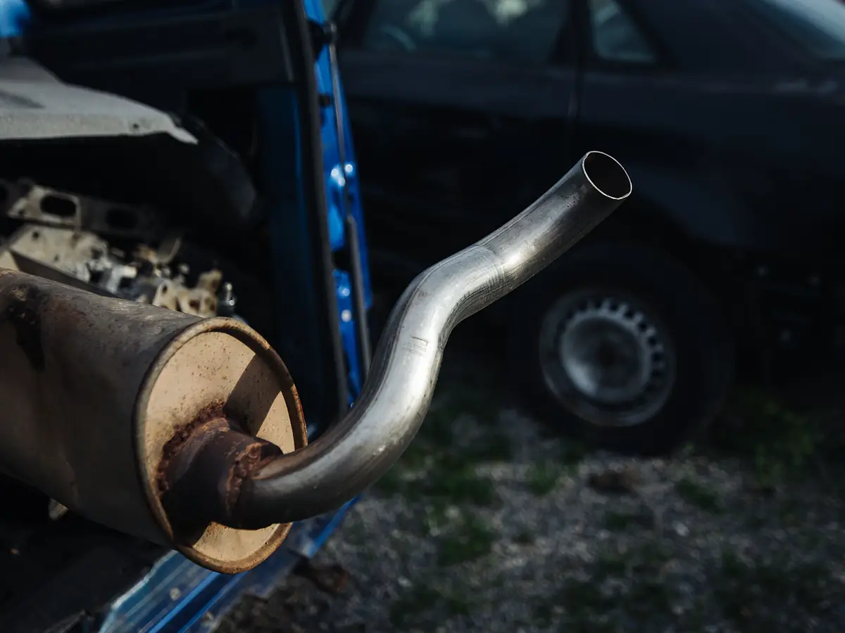 Exhaust pipe and muffler running beneath a vehicle raised on a lift