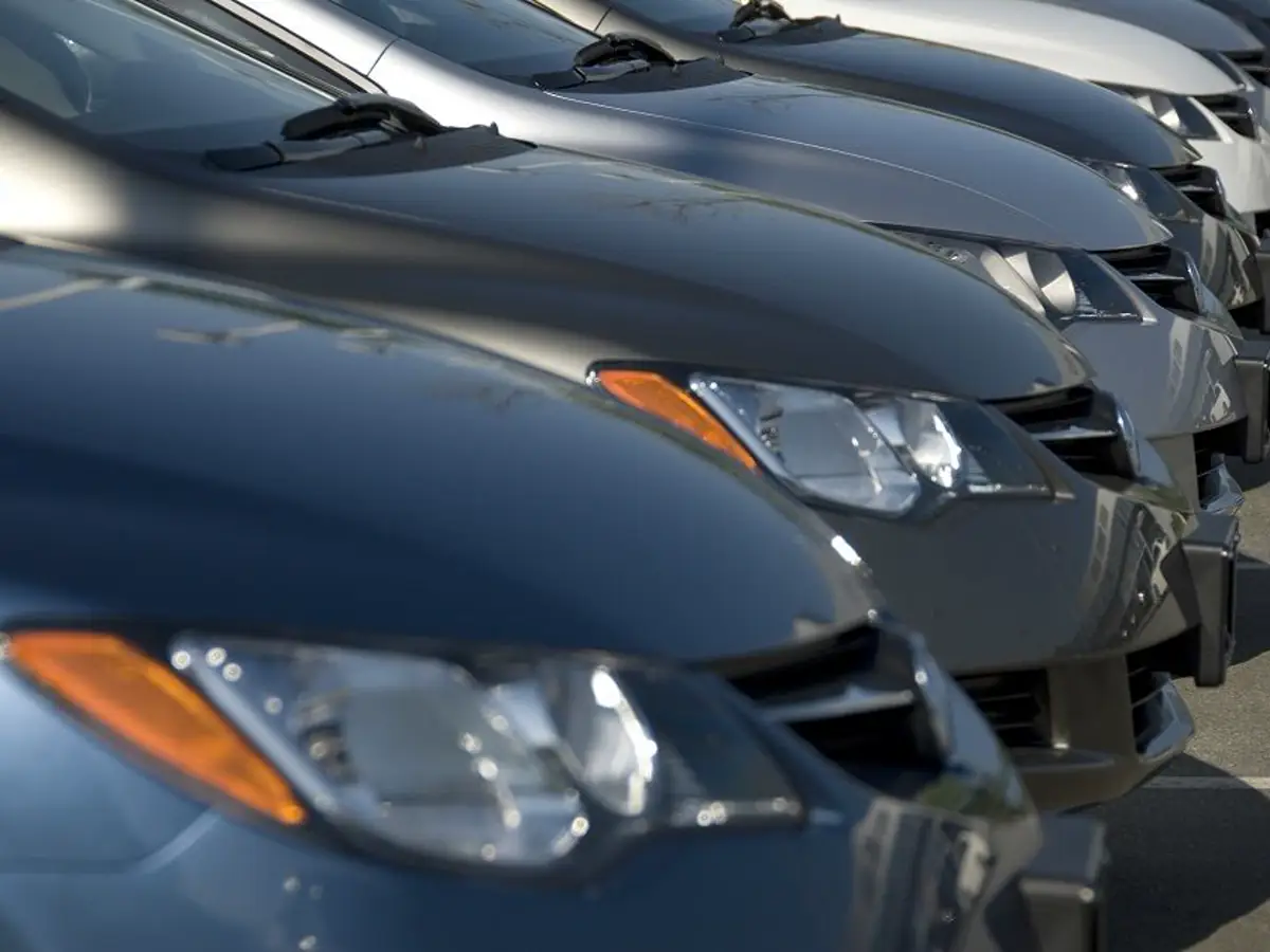 Row of parked sedans seen from the front at a slight angle